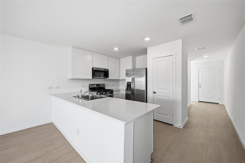 1613 Elliott Road Howe, TX 75459 - Photo 6 of 19 a kitchen with stainless steel appliances a refrigerator sink and microwave