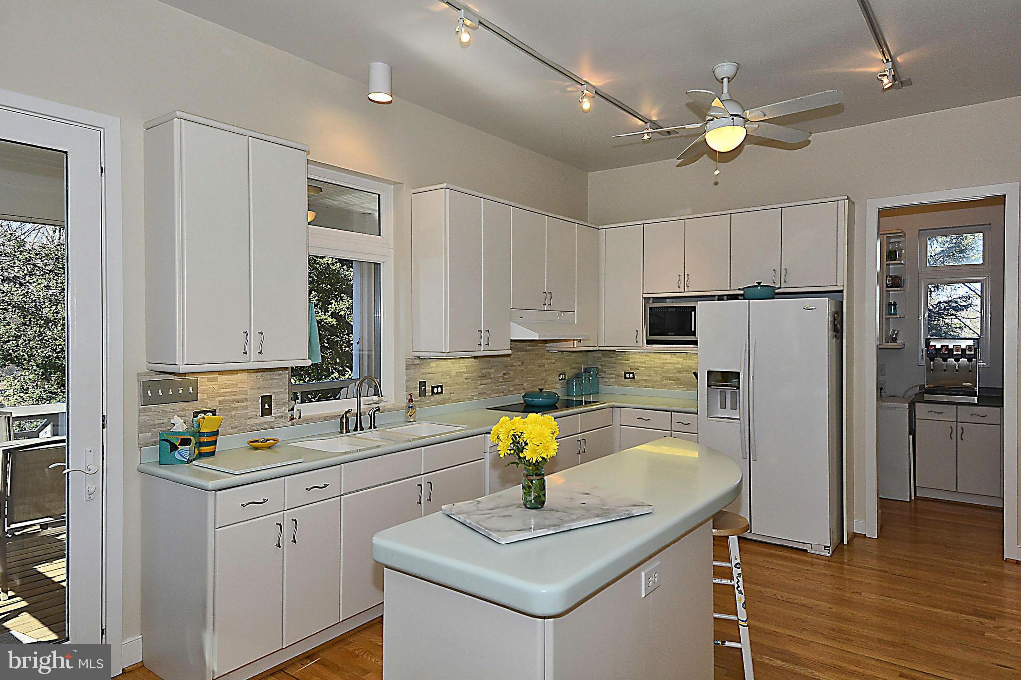 823 Rowen Road Silver Spring, MD 20910 - Photo 11 of 30 a kitchen with a refrigerator a sink a stove a counter space and cabinets