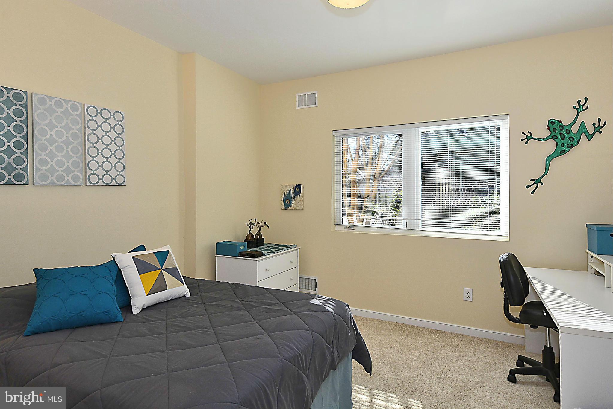823 Rowen Road Silver Spring, MD 20910 - Photo 20 of 30 a bedroom with a bed and wooden floor