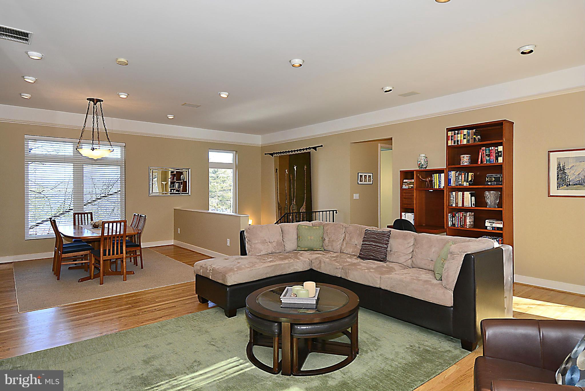 823 Rowen Road Silver Spring, MD 20910 - Photo 4 of 30 a living room with furniture and a dining table with wooden floor