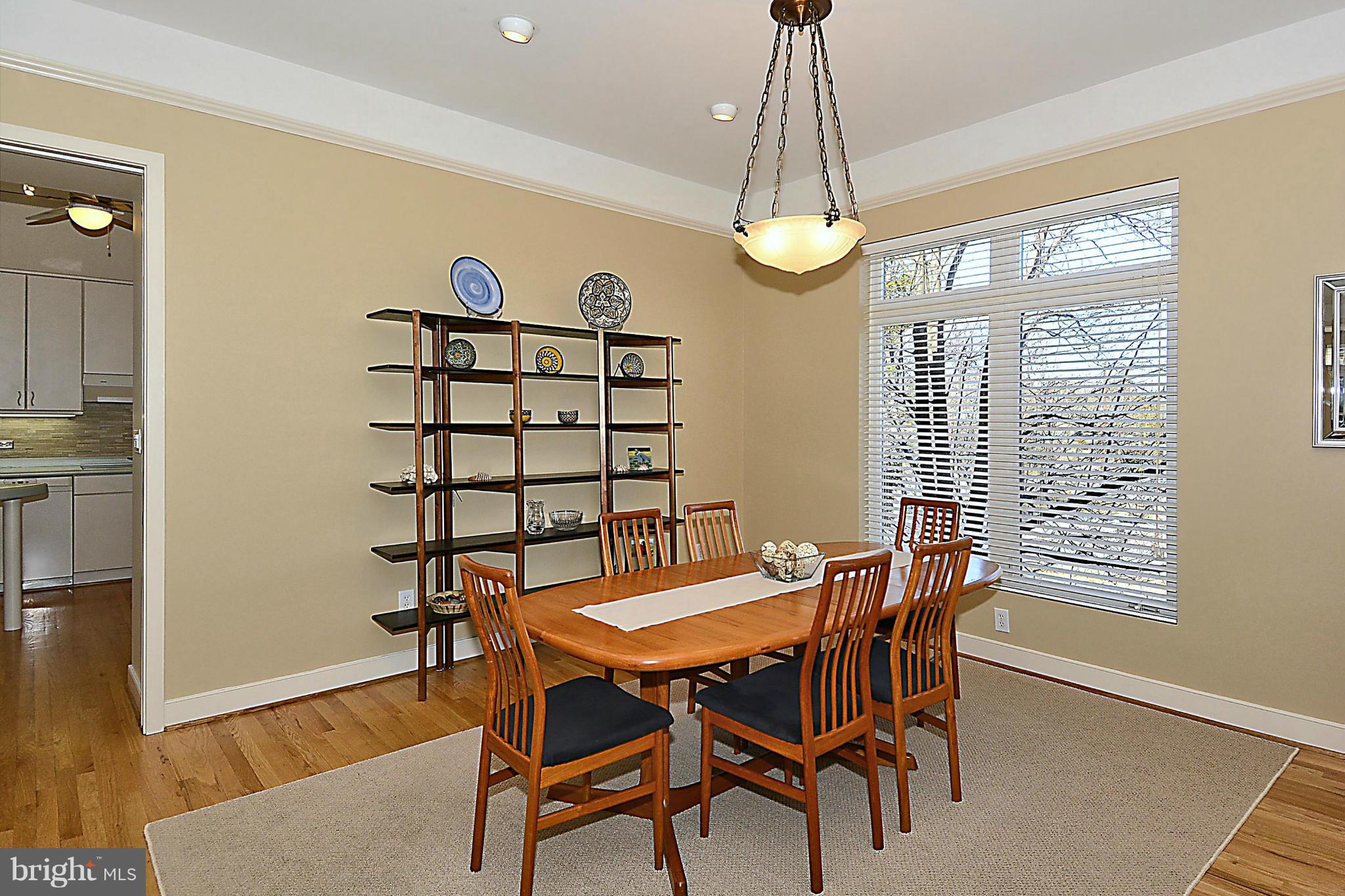 823 Rowen Road Silver Spring, MD 20910 - Photo 8 of 30 a dining room with furniture a chandelier and wooden floor