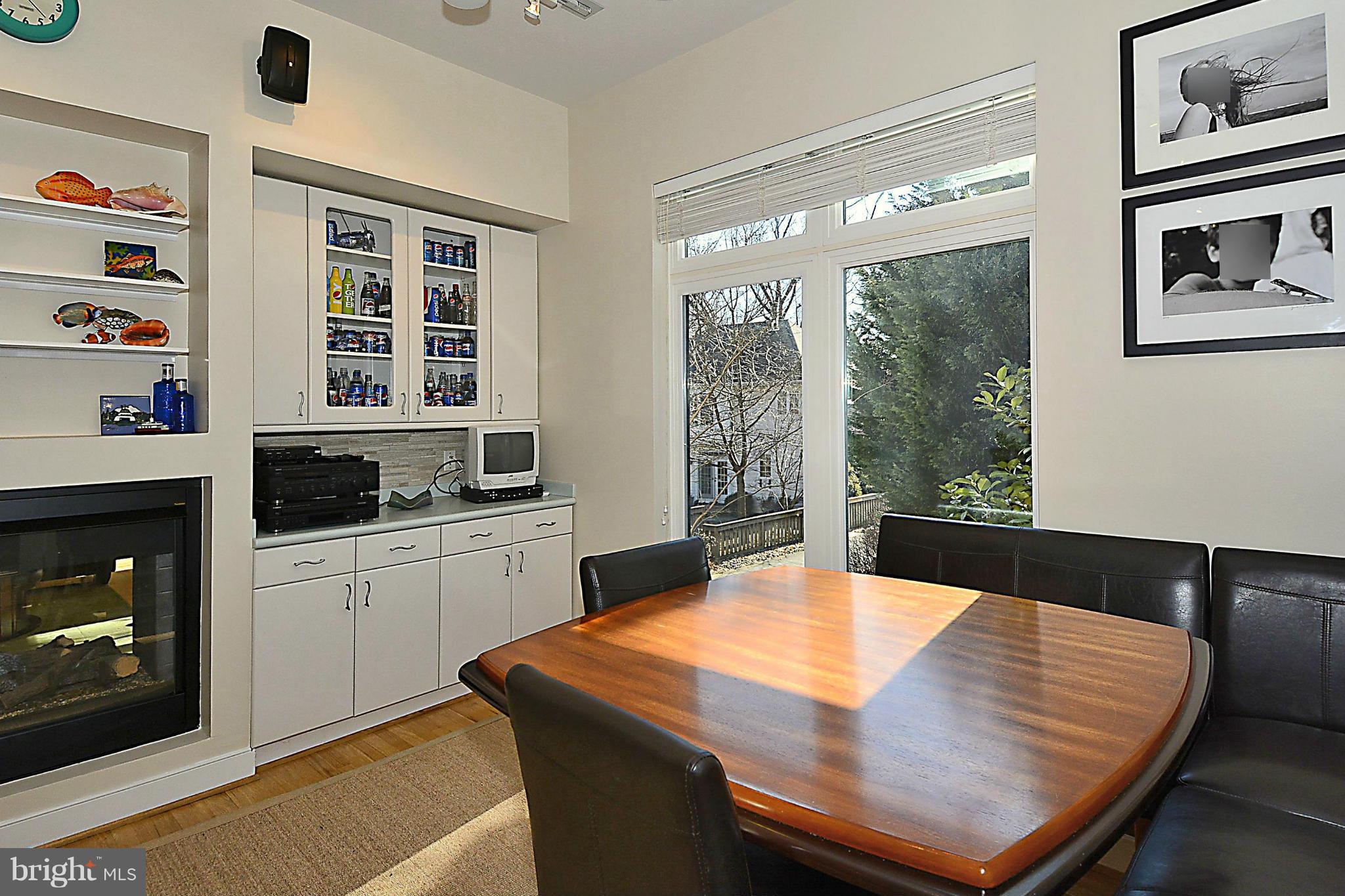823 Rowen Road Silver Spring, MD 20910 - Photo 10 of 30 a kitchen with a table chairs and a refrigerator