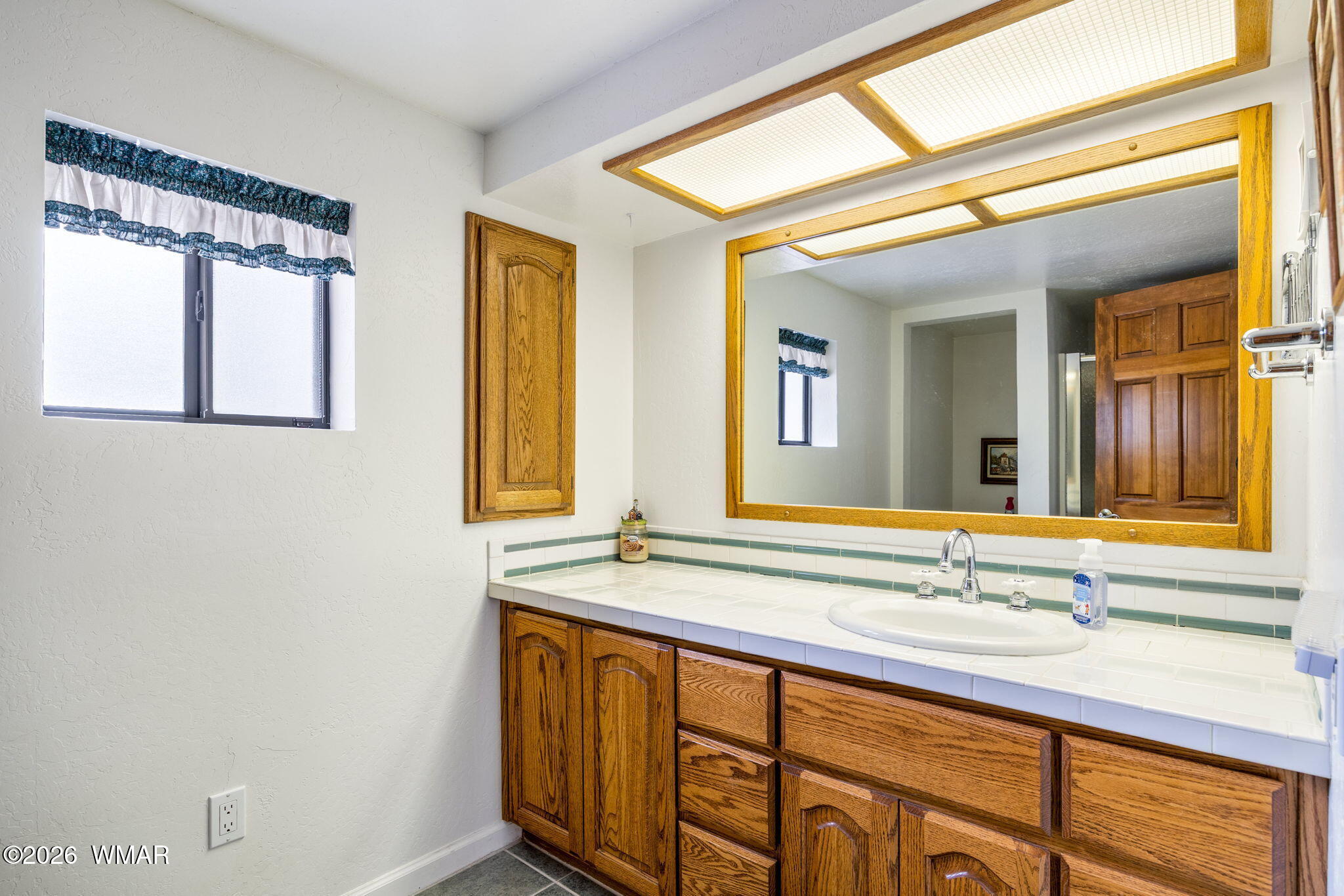 2922 Pine Rim Road Overgaard, AZ 85933 - Photo 38 of 58 a bathroom with a granite countertop sink and a large mirror