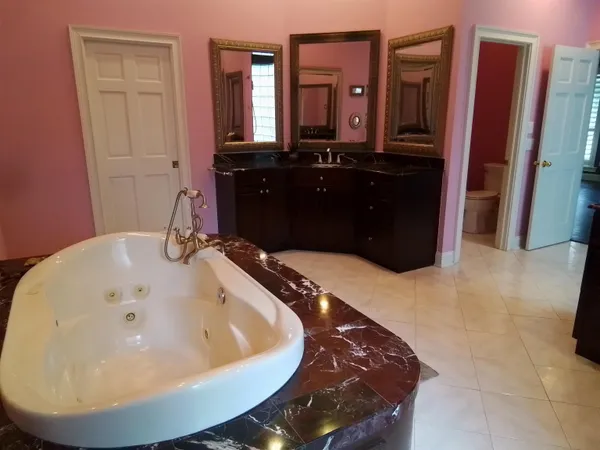 a bathroom with a toilet a sink and mirror