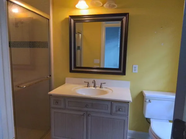 a living room with a couch and a book shelf
