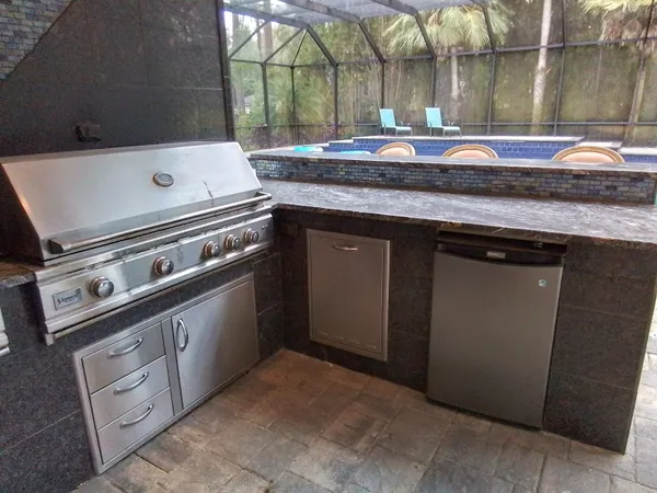 a front view of a house with a yard and palm trees