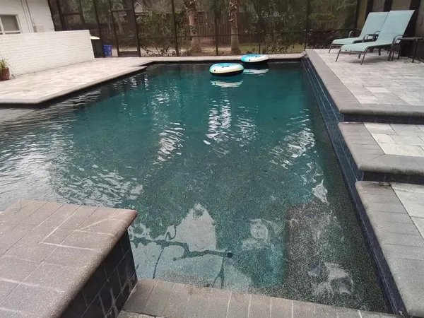 a front view of a house with plants