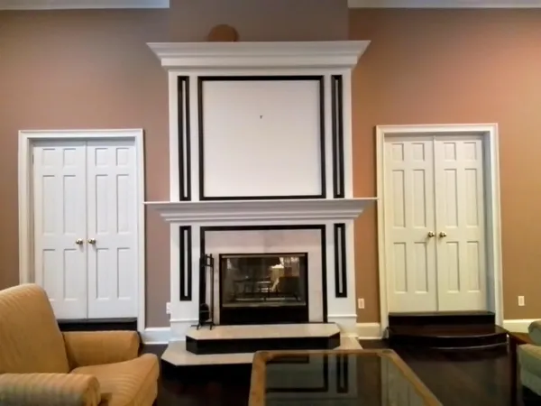 a bathroom with a sink a large mirror and a clock