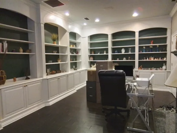 a large kitchen with lots of counter space and wooden floor