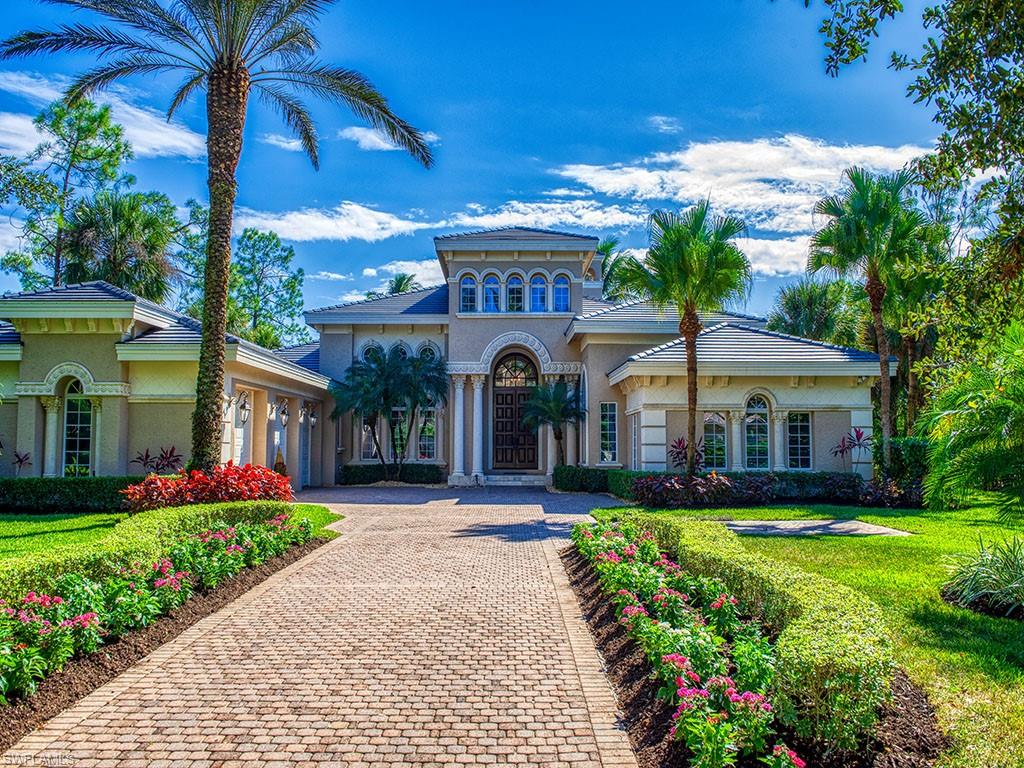 a front view of a house with a garden and plants