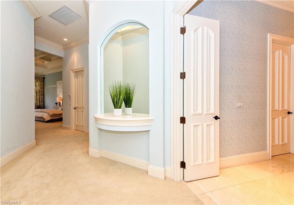 3110 Dahlia Way Naples, FL 34105 - Photo 12 of 35 a view of a bathroom with tub and mirror