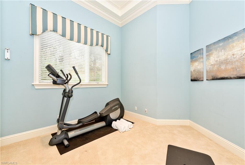 3110 Dahlia Way Naples, FL 34105 - Photo 14 of 35 a bedroom with a bed and gym equipment