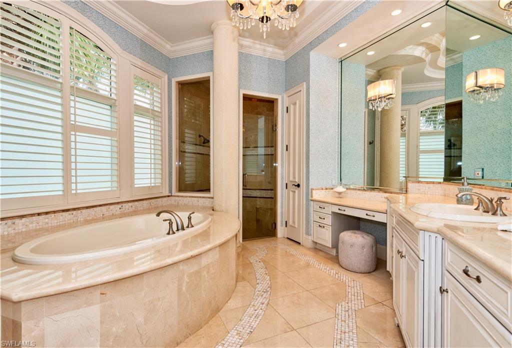 3110 Dahlia Way Naples, FL 34105 - Photo 15 of 35 a spacious bathroom with a tub sink and mirror