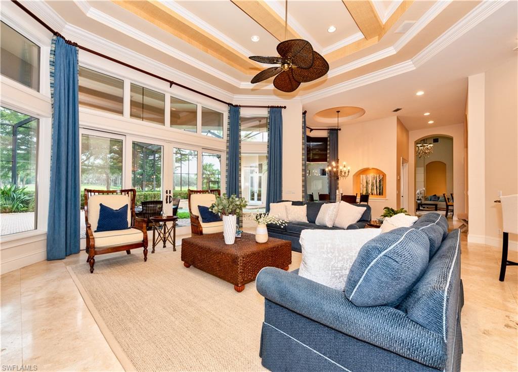 3110 Dahlia Way Naples, FL 34105 - Photo 24 of 35 a living room with furniture ceiling fan and a large window