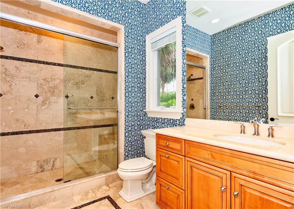 3110 Dahlia Way Naples, FL 34105 - Photo 25 of 35 a bathroom with a sink a toilet and shower