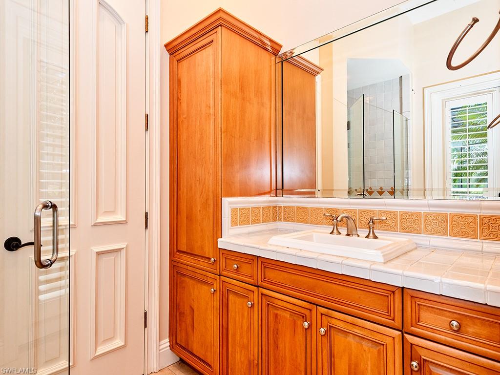 3110 Dahlia Way Naples, FL 34105 - Photo 35 of 35 a bathroom with a sink and a mirror