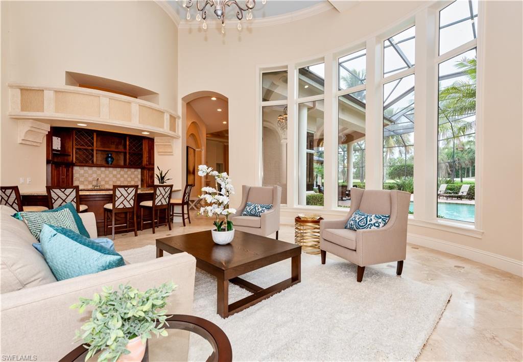 3110 Dahlia Way Naples, FL 34105 - Photo 6 of 35 a living room with fireplace furniture and a large window