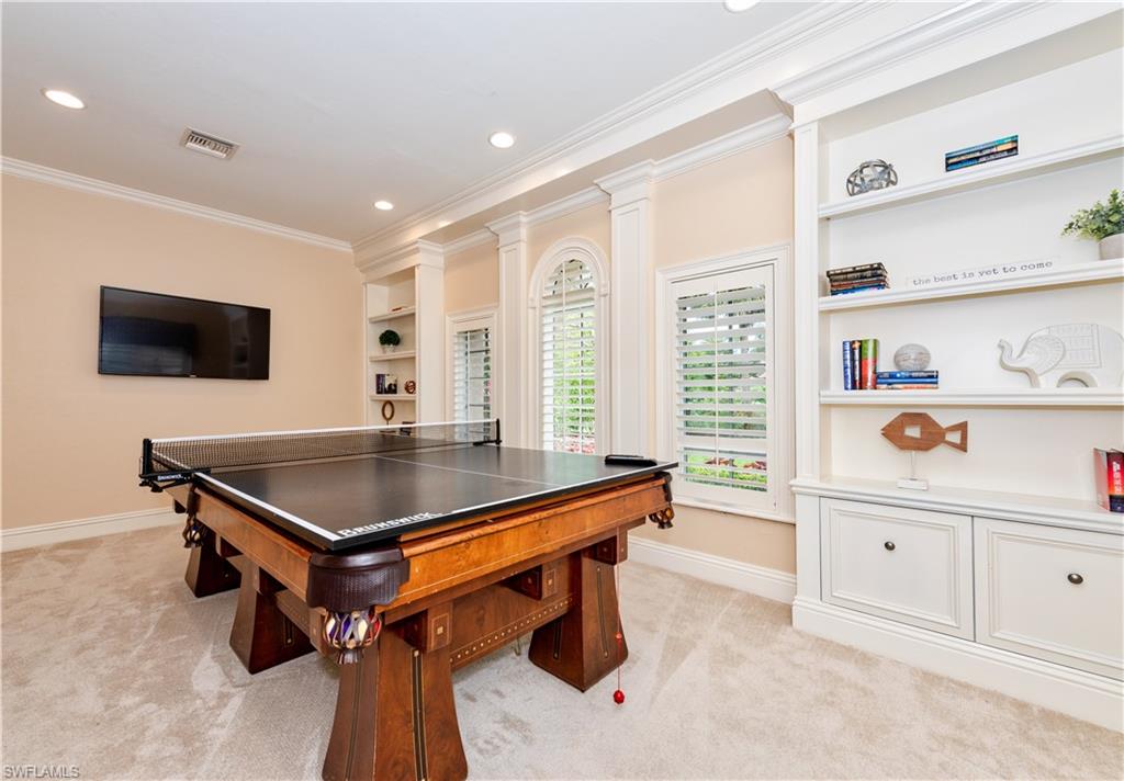 3110 Dahlia Way Naples, FL 34105 - Photo 8 of 35 a room with pool table and flat screen tv
