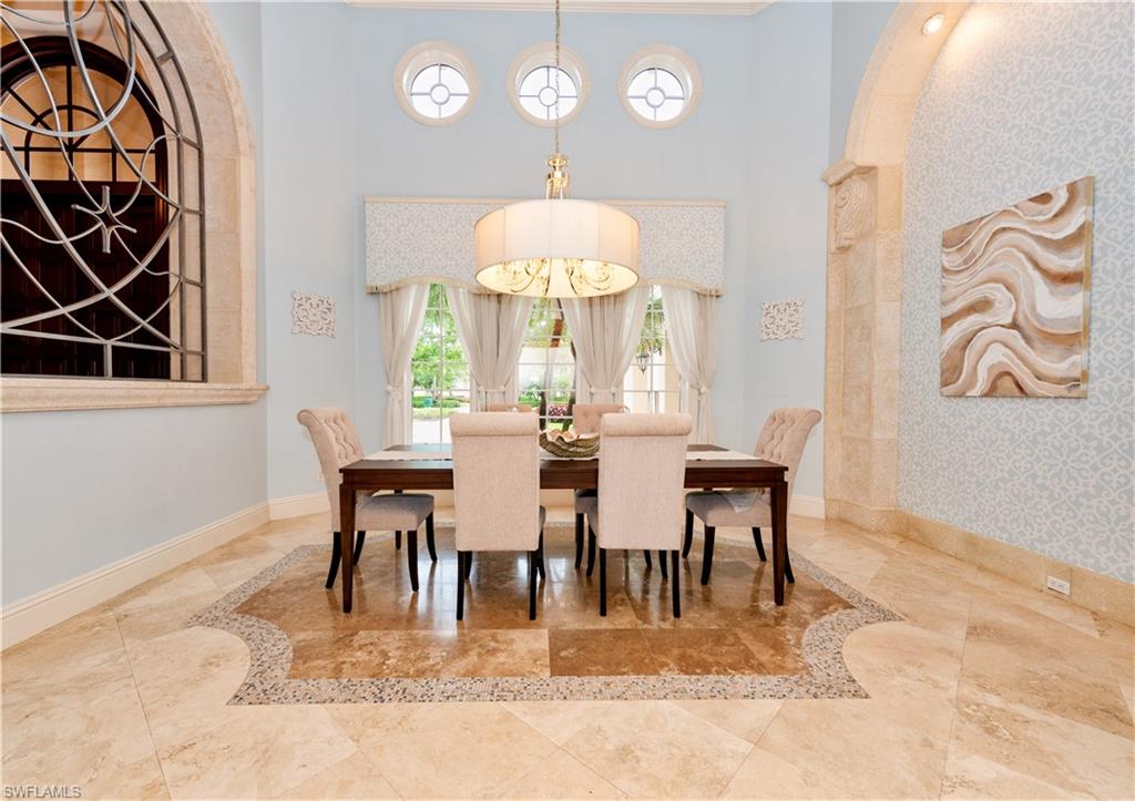 3110 Dahlia Way Naples, FL 34105 - Photo 9 of 35 a view of a dining room with furniture and chandelier