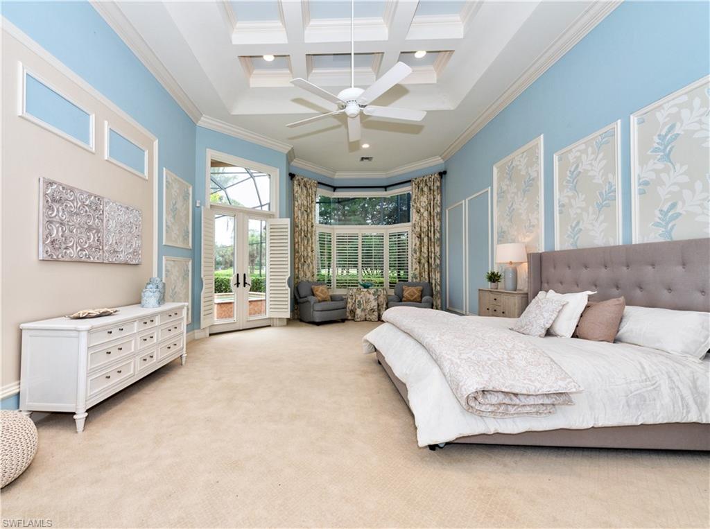 3110 Dahlia Way Naples, FL 34105 - Photo 10 of 35 a spacious bedroom with a bed couch and large window