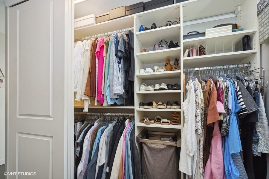 3033 North Sheridan Road, Unit 1201 Chicago, IL 60657 - Photo 13 of 16 a view of walk in closet with clothes and shoes