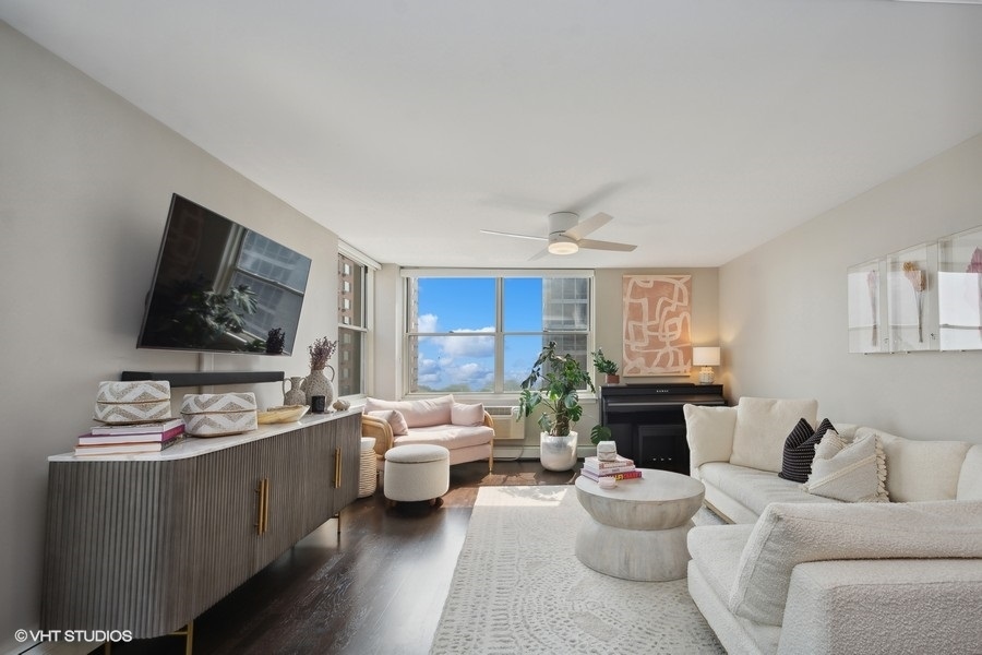 3033 North Sheridan Road, Unit 1201 Chicago, IL 60657 - Photo 2 of 16 a living room with furniture and a flat screen tv