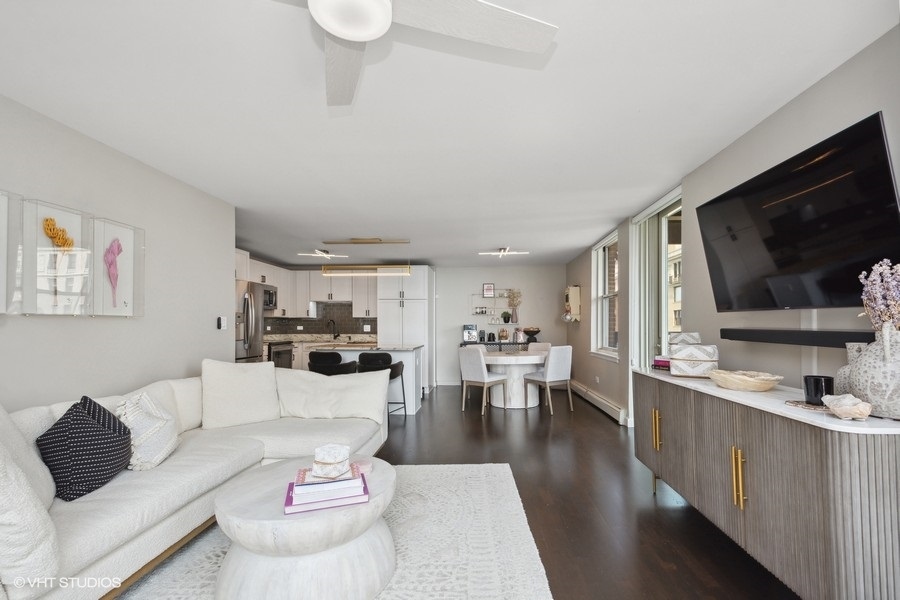 3033 North Sheridan Road, Unit 1201 Chicago, IL 60657 - Photo 4 of 16 a living room with furniture flat screen tv and kitchen view
