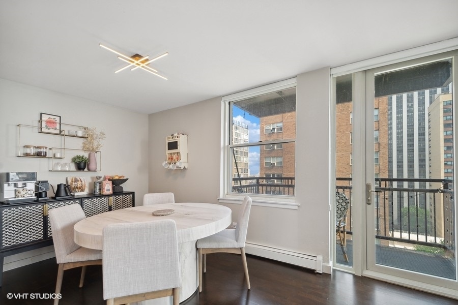3033 North Sheridan Road, Unit 1201 Chicago, IL 60657 - Photo 6 of 16 a dining room with furniture and window