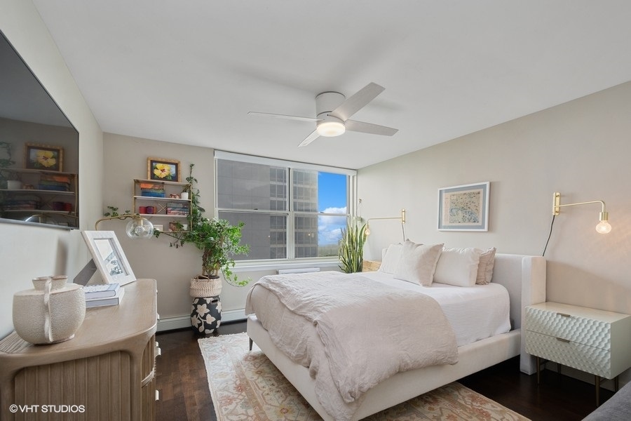 3033 North Sheridan Road, Unit 1201 Chicago, IL 60657 - Photo 7 of 16 a bedroom with a large bed and a couch