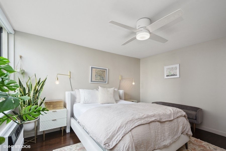 3033 North Sheridan Road, Unit 1201 Chicago, IL 60657 - Photo 8 of 16 a bedroom with a bed and a chandelier