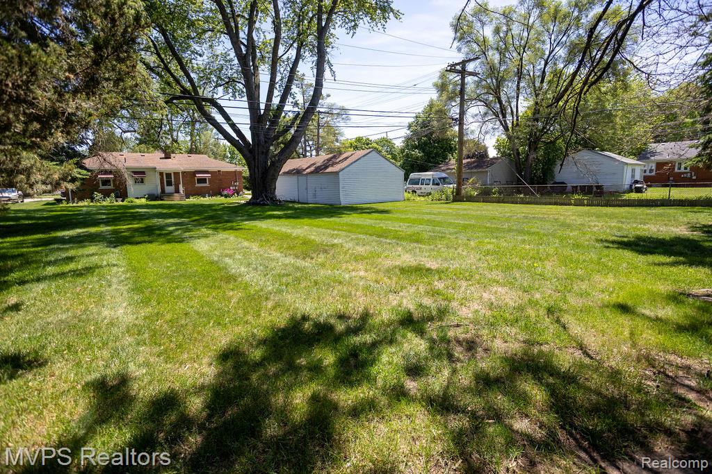 33033 Edgegrove Road Fraser, MI 48026 - Photo 5 of 20 Expansive green lawn with mature trees providing partial shade
