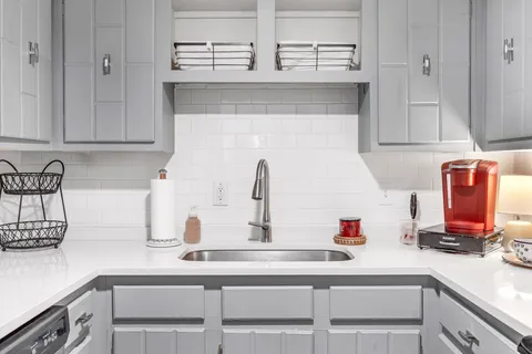 a kitchen with a sink and cabinets