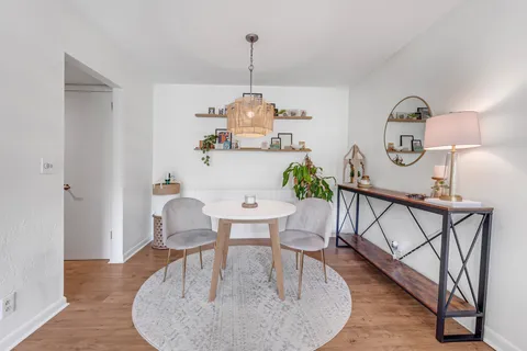 a view of a dining room with furniture window and wooden floor