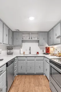 a kitchen with a sink cabinets and appliances