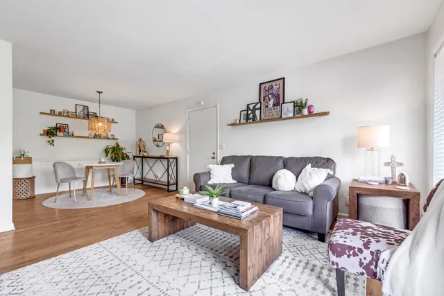 a living room with furniture and wooden floor