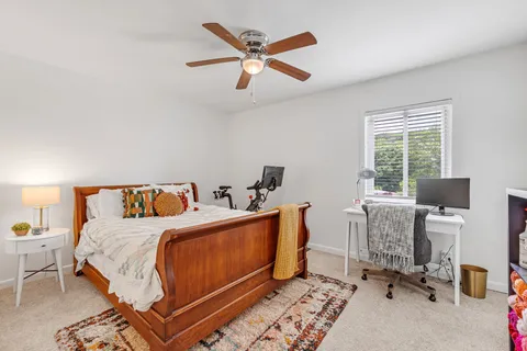 a bed room with a bed and a chair