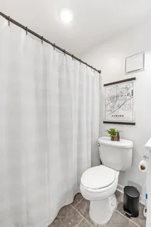 a white toilet sitting next to a shower curtain