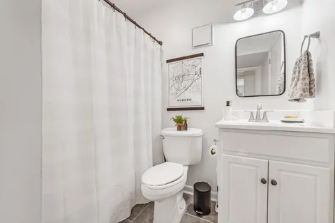 a bathroom with a toilet a sink and a mirror