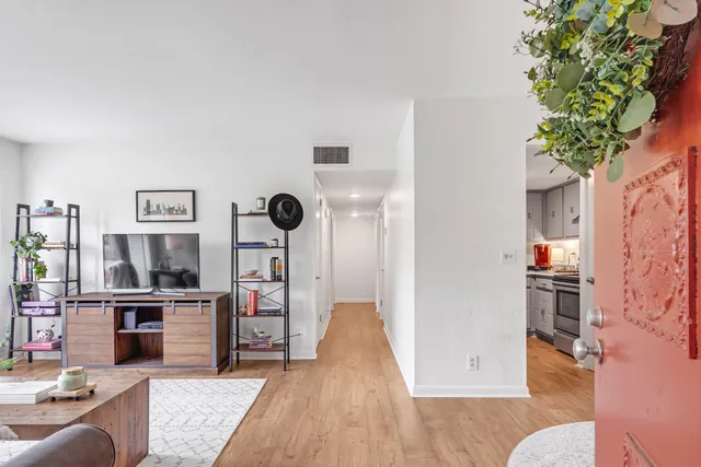a living room with furniture and kitchen view