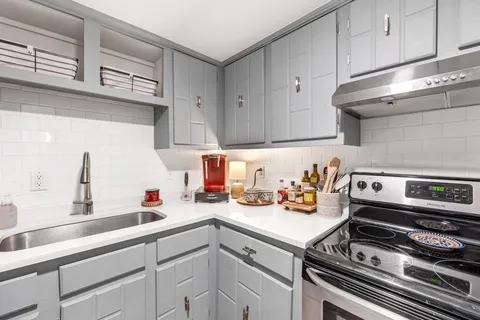 a kitchen with a sink and cabinets
