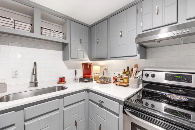 a kitchen with a sink and cabinets