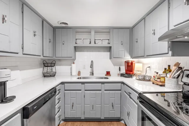 a kitchen with a sink cabinets and window