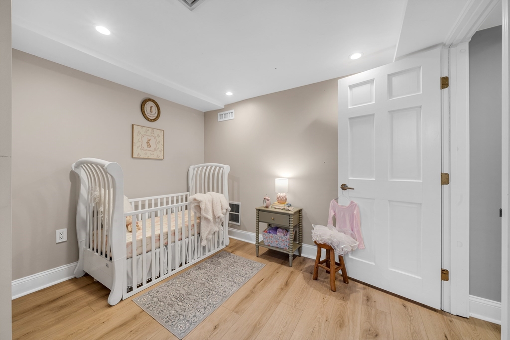 93 Baldwin Street, Unit 1 Boston, MA 02129 - Photo 23 of 30 a room with a white bed and furniture