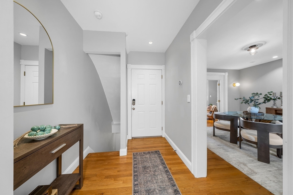 93 Baldwin Street, Unit 1 Boston, MA 02129 - Photo 3 of 30 a hallway with wooden floor and furniture