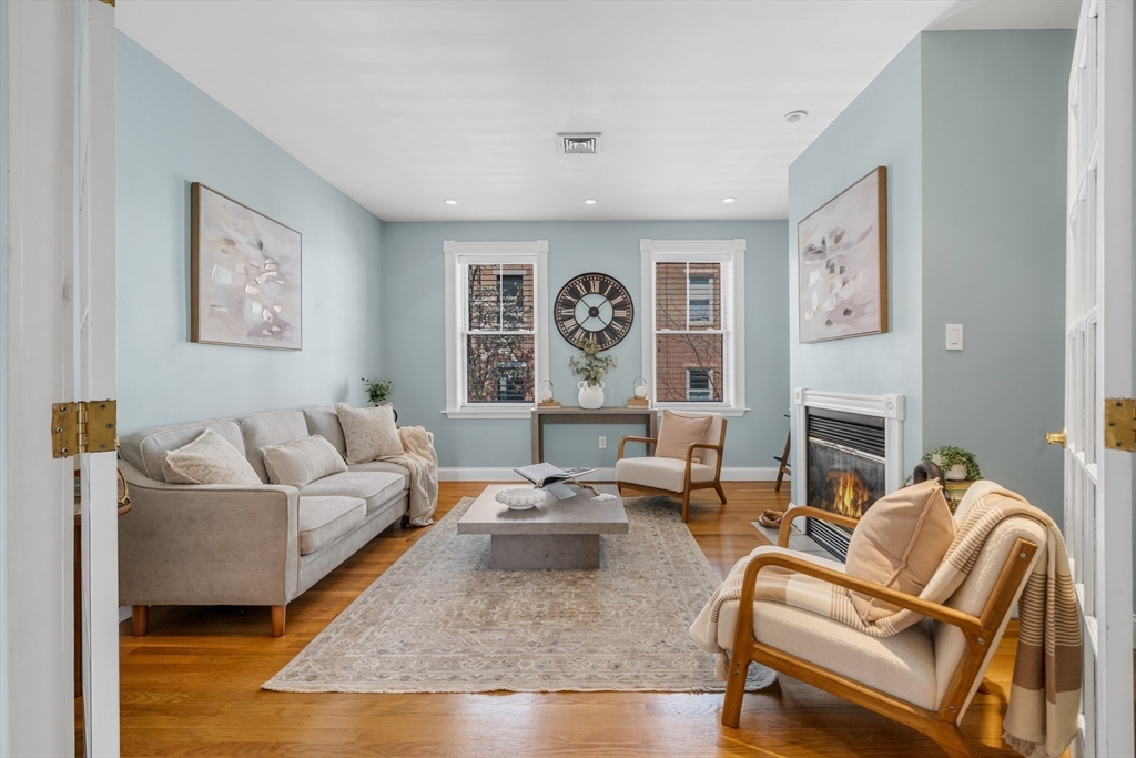 93 Baldwin Street, Unit 1 Boston, MA 02129 - Photo 6 of 30 a living room with fireplace furniture and a fireplace