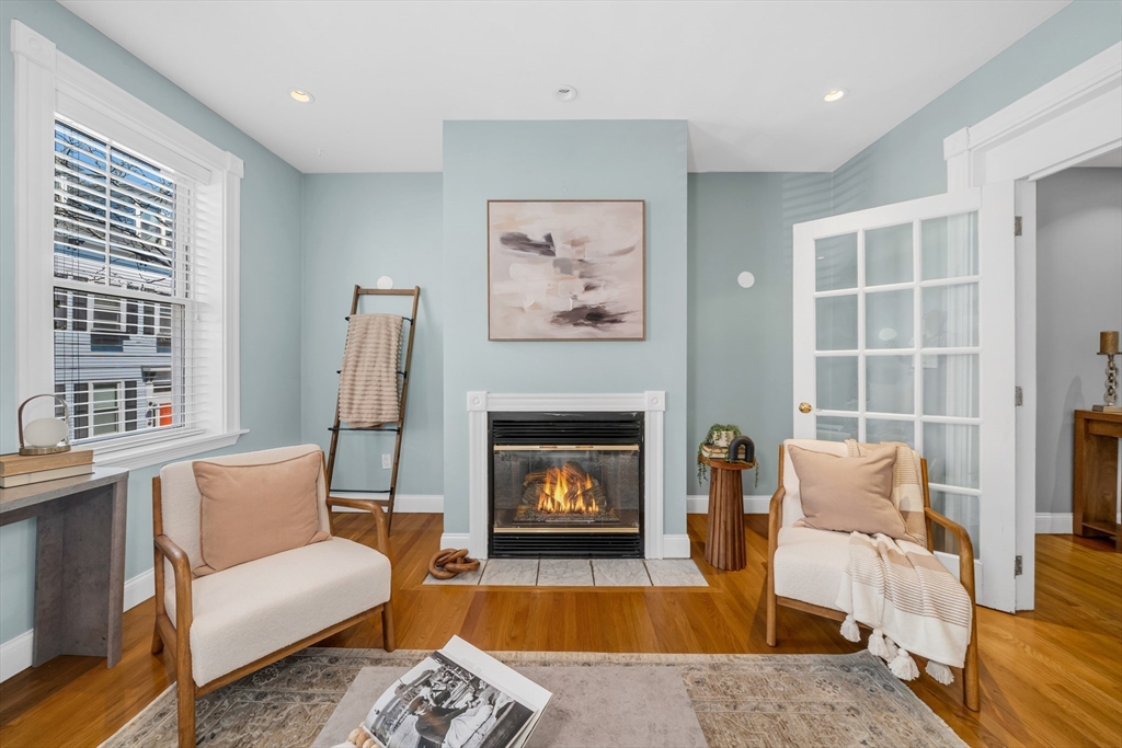 93 Baldwin Street, Unit 1 Boston, MA 02129 - Photo 9 of 30 a living room with furniture and a fireplace