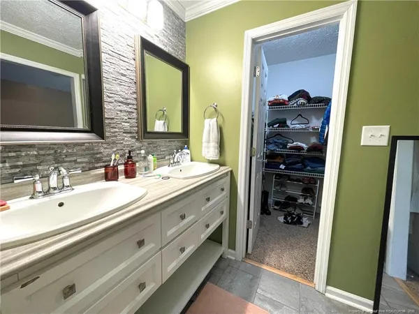 a bathroom with a double vanity sink and mirror