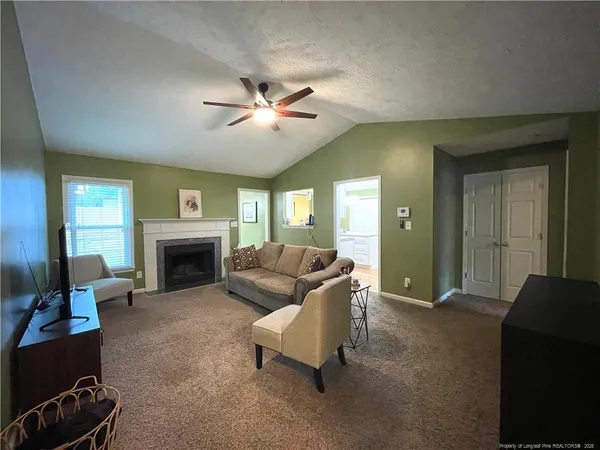a living room with furniture and a fireplace