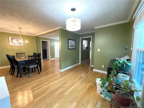 a view of a dining room with furniture and wooden floor