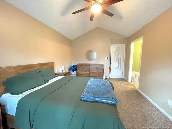 a bed sitting in a bedroom and a chandelier